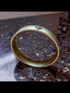 Matte Gold Bangle Bracelet with Beaded Edge and Floral Accent